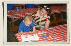 Kyle Piper and Heather Piper reading a book at a picnic 