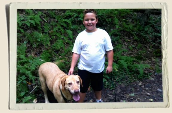 Kyle-Piper-Scooby-in-woods Kyle Piper and Scooby walking in the woods