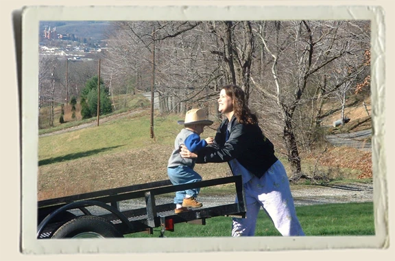 Kyle and Aunt Heather Piper in yard on a trailer 
