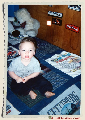 Kyle-on-his-quilt-Aunt-Heather-Piper-made-2002