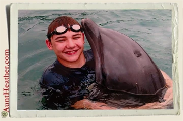 Kyle-swimming-with-dolphin-on-cruise-6-2015-Aunt-Heather-Piper